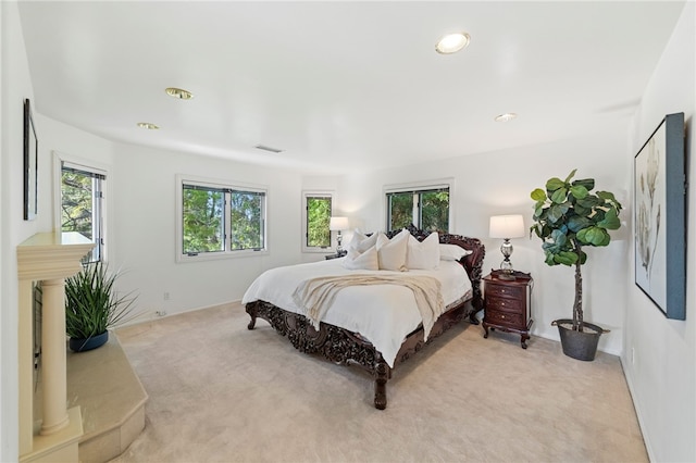 carpeted bedroom featuring multiple windows