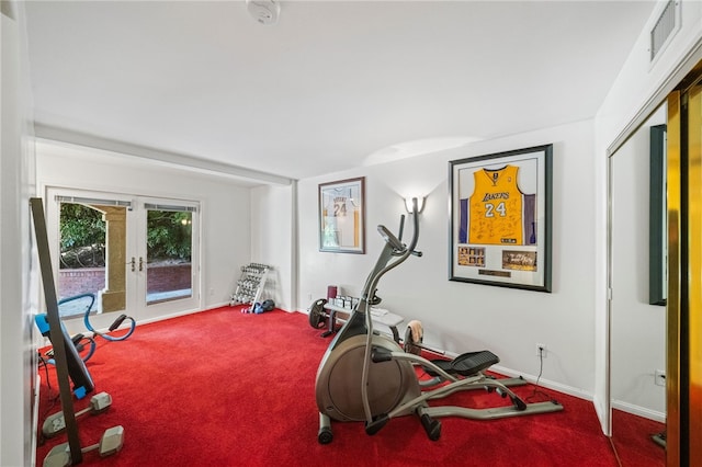 workout area with carpet floors and french doors