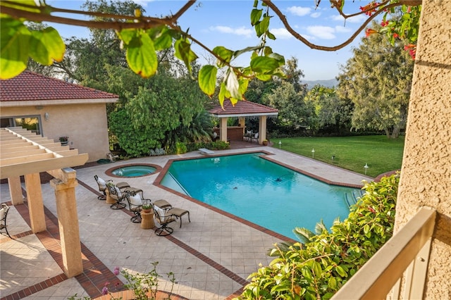 view of swimming pool featuring an in ground hot tub, a patio area, a gazebo, and a lawn