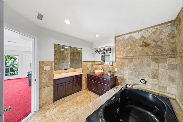 bathroom with a washtub, tile walls, and vanity