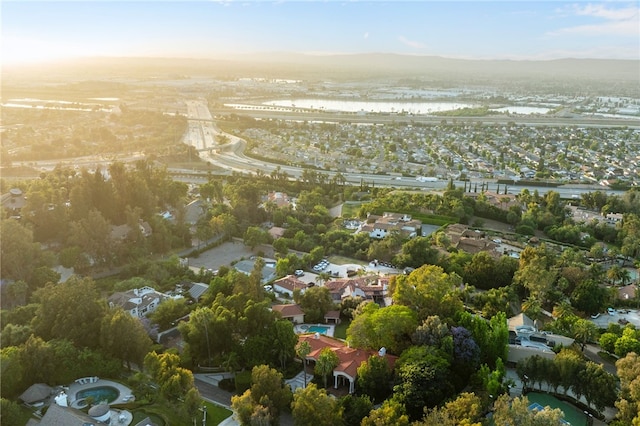 aerial view at dusk featuring a water view