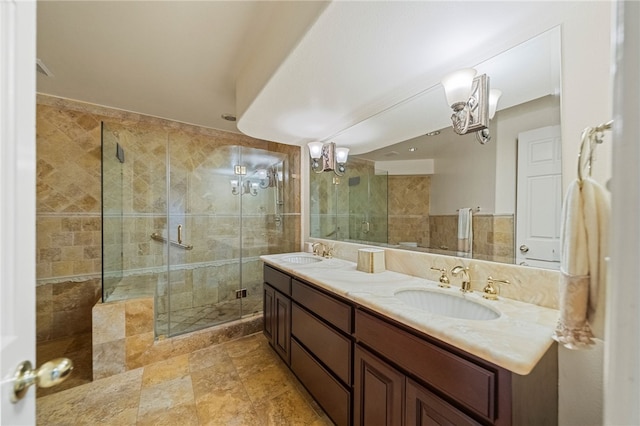 bathroom with tile walls, a shower with door, and vanity