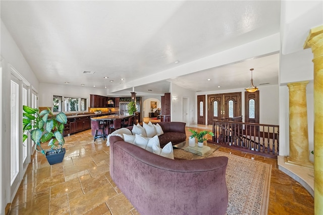 living room featuring ornate columns