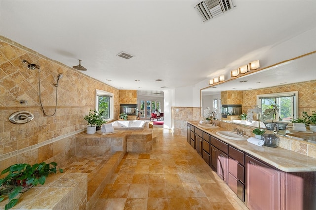 bathroom with ceiling fan, vanity, and independent shower and bath