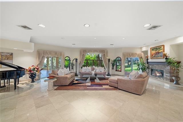 living room featuring a tiled fireplace