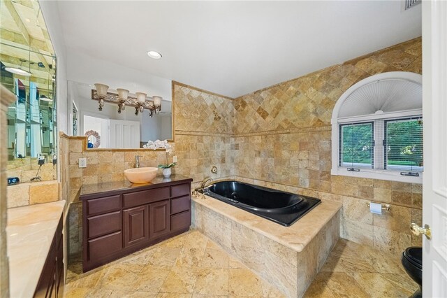 bathroom featuring tile walls, a bathtub, and vanity