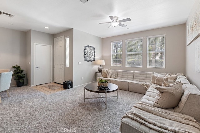 carpeted living room with ceiling fan