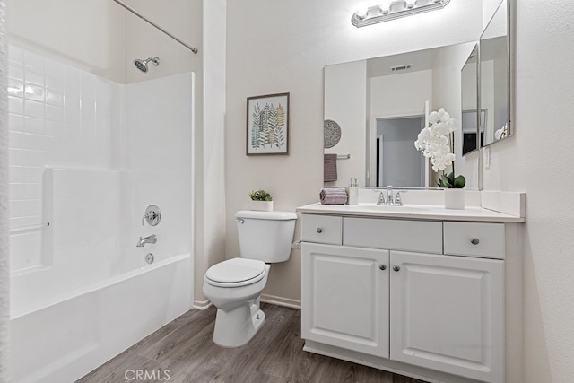 full bathroom with shower / tub combination, vanity, hardwood / wood-style flooring, and toilet