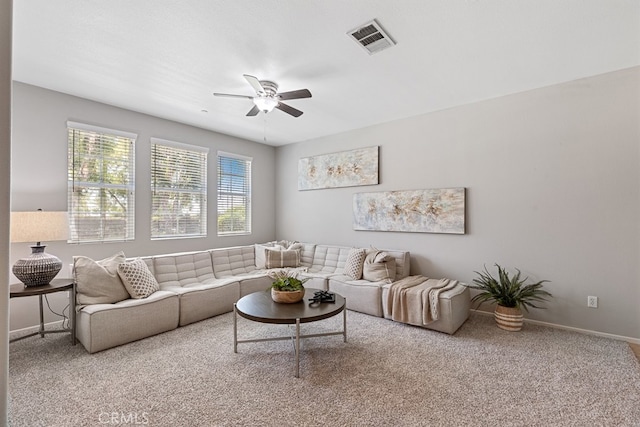 carpeted living room featuring ceiling fan