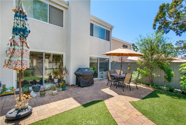 rear view of property featuring a patio area