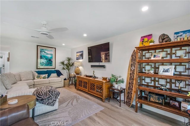 living room featuring ceiling fan and light wood-type flooring