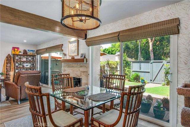 dining space featuring a premium fireplace and light hardwood / wood-style flooring