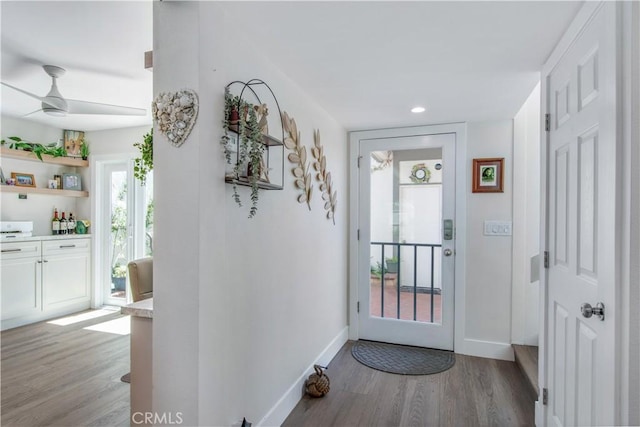 doorway to outside featuring light wood-type flooring and ceiling fan