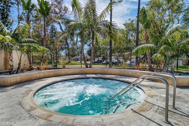 view of pool with a hot tub