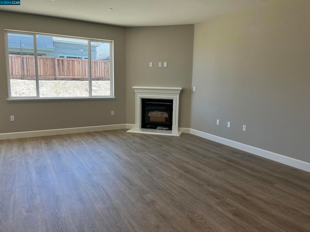 unfurnished living room featuring hardwood / wood-style flooring