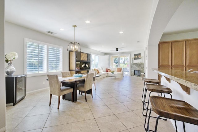 dining area featuring light tile patterned floors, a wealth of natural light, and ceiling fan