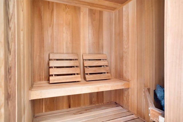 view of sauna / steam room featuring wooden walls and hardwood / wood-style floors