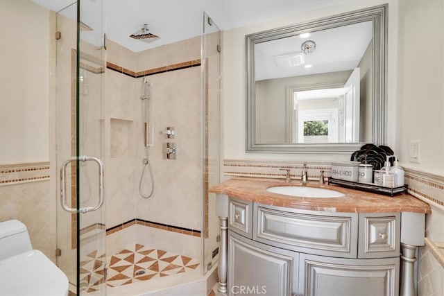 bathroom with vanity, an enclosed shower, and toilet