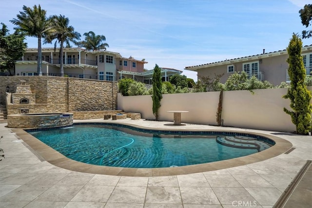 view of swimming pool with an in ground hot tub