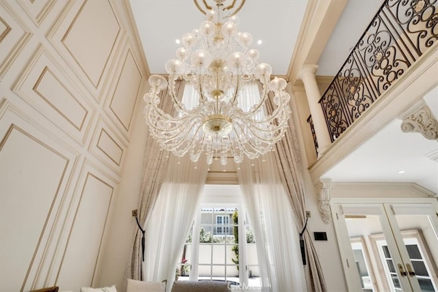 interior details featuring ornamental molding and a chandelier