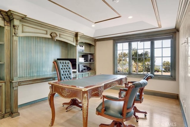 office area with a tray ceiling, crown molding, and light hardwood / wood-style flooring