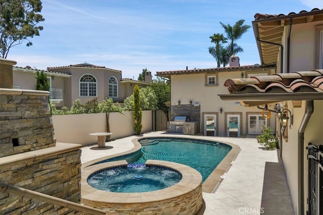 view of swimming pool with a patio and an in ground hot tub