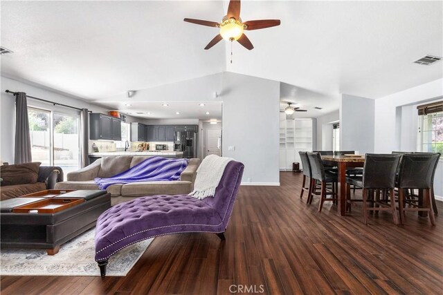 living room featuring vaulted ceiling, ceiling fan, dark wood-type flooring, and sink