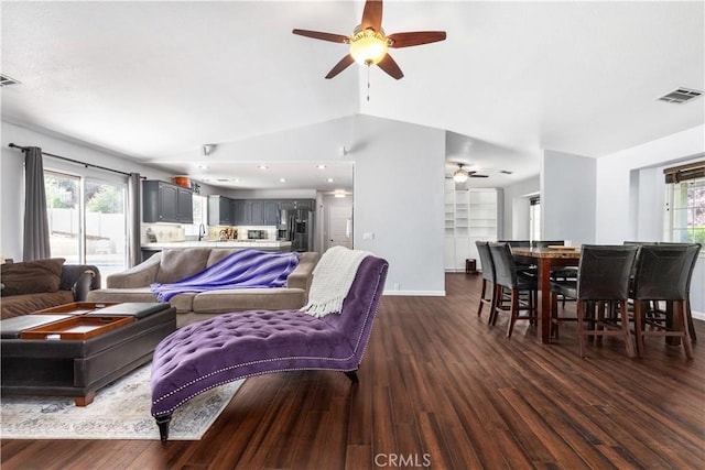 living room featuring ceiling fan, sink, dark hardwood / wood-style flooring, and vaulted ceiling