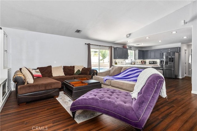 living room featuring dark wood-type flooring and lofted ceiling