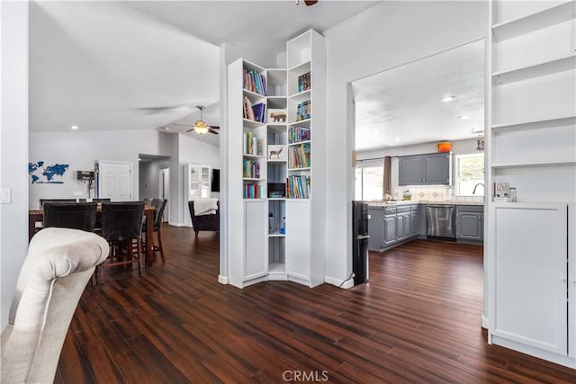 interior space with ceiling fan, dark hardwood / wood-style flooring, and lofted ceiling