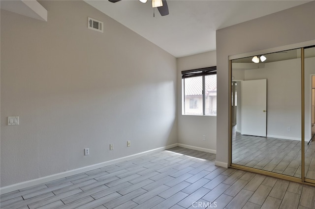 unfurnished room with ceiling fan, light hardwood / wood-style flooring, and vaulted ceiling