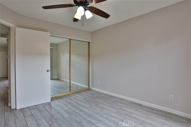 unfurnished bedroom with light hardwood / wood-style floors, ceiling fan, and a closet