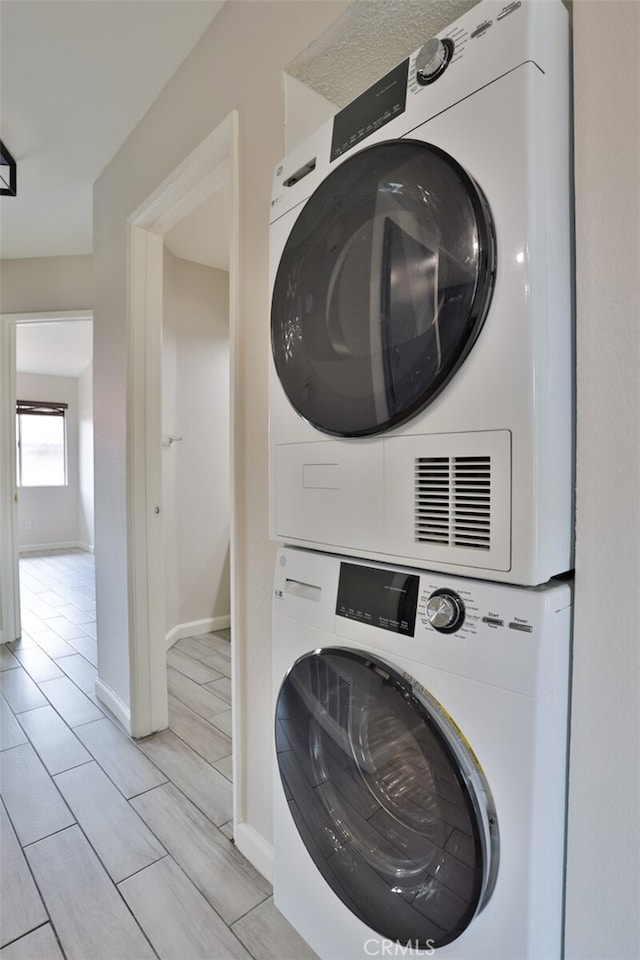 clothes washing area with stacked washer / drying machine