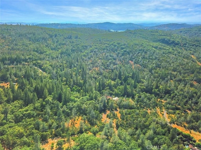 aerial view featuring a forest view and a mountain view
