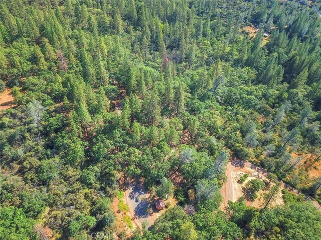 aerial view featuring a wooded view