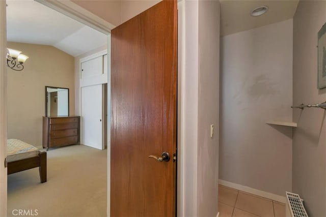 bathroom featuring tile patterned floors and vaulted ceiling