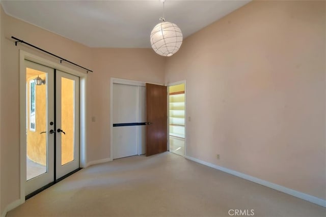 spare room with light carpet, french doors, and a healthy amount of sunlight