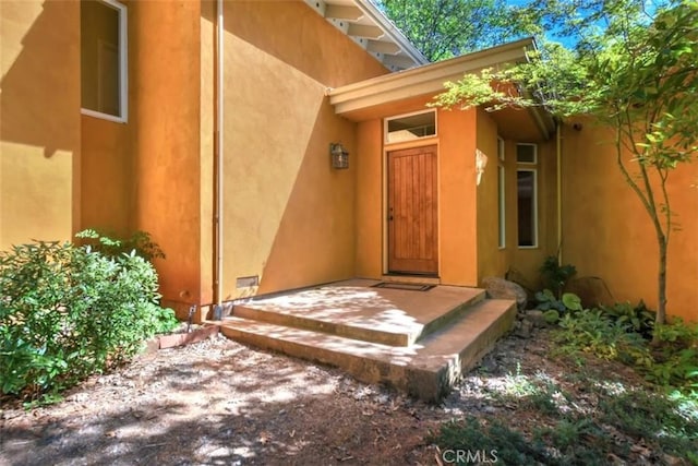 doorway to property with stucco siding