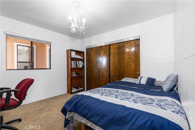 carpeted bedroom featuring a notable chandelier and a closet