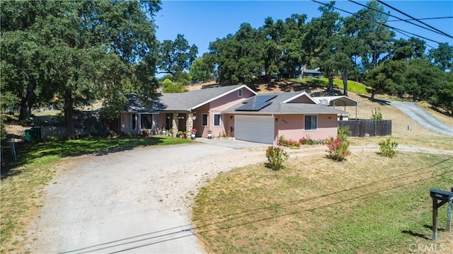 ranch-style house with a garage and a front yard