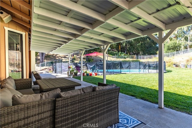 view of terrace with outdoor lounge area, a trampoline, and a fenced in pool