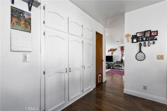 hall with dark hardwood / wood-style floors