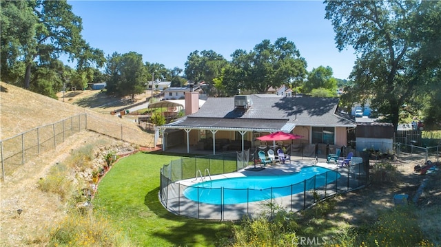 view of swimming pool with a yard and a patio