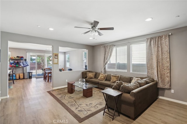 living room featuring ceiling fan, french doors, and light hardwood / wood-style floors