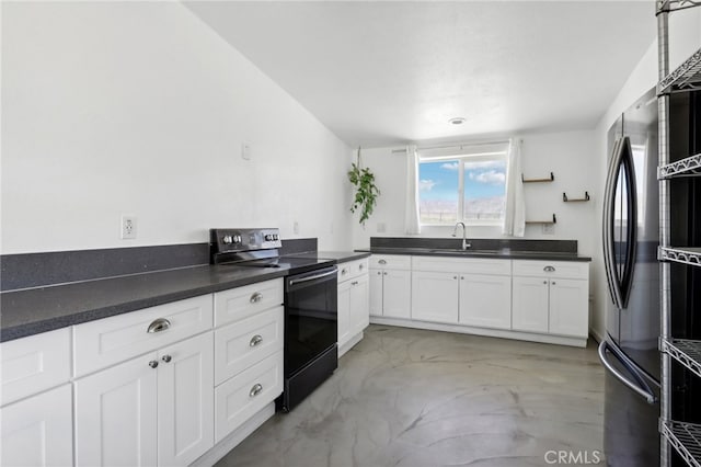 kitchen featuring stainless steel refrigerator, white cabinetry, sink, black electric range, and a textured ceiling