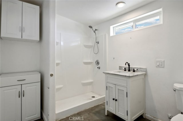 bathroom with vanity, toilet, and walk in shower