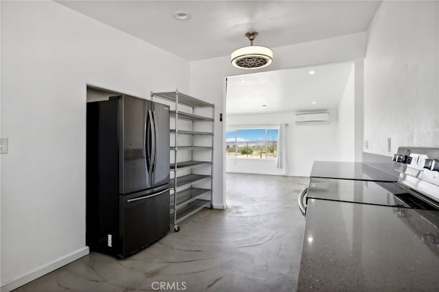 kitchen with a wall mounted AC, stainless steel fridge, and stove