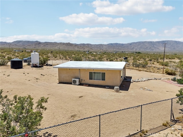 exterior space featuring a mountain view and ac unit