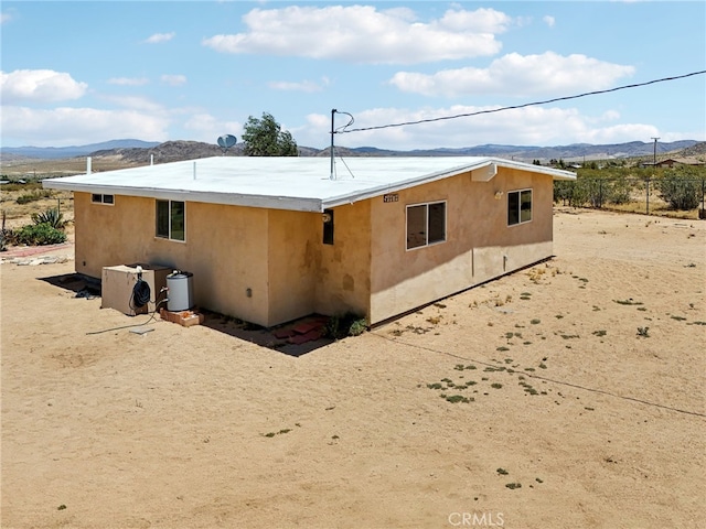 back of house with a mountain view