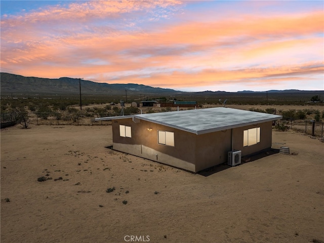 exterior space with a mountain view and central AC